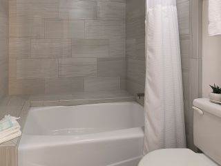 A White Tub Sitting Next To A Shower Curtain